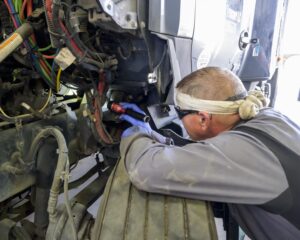 Mechanic fixing semi truck that keep derating