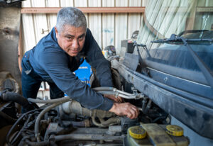 Ferguson Truck Center repair tech working on a fuel line system on a commercial truck