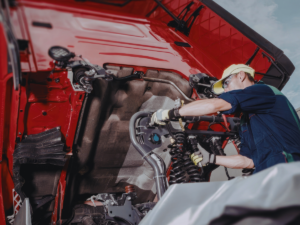 Mechanic fixing semi truck that won't start